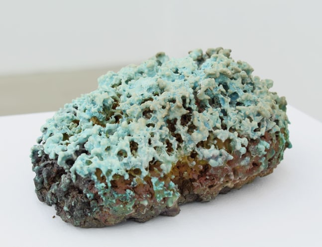 Photograph of a green and brown porcelain sculpture of moss