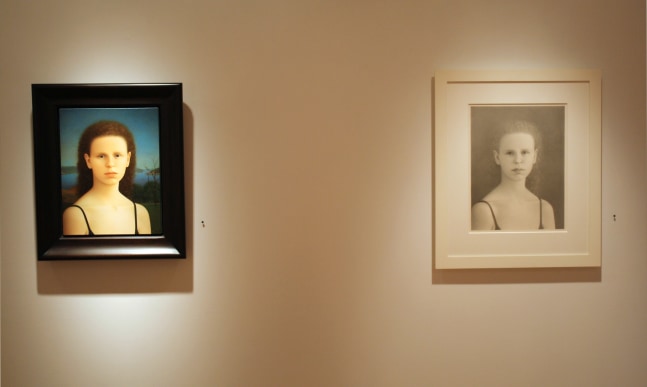 Photograph showing a view of an exhibition, with one small framed painting and one small framed drawing hanging on a white wall