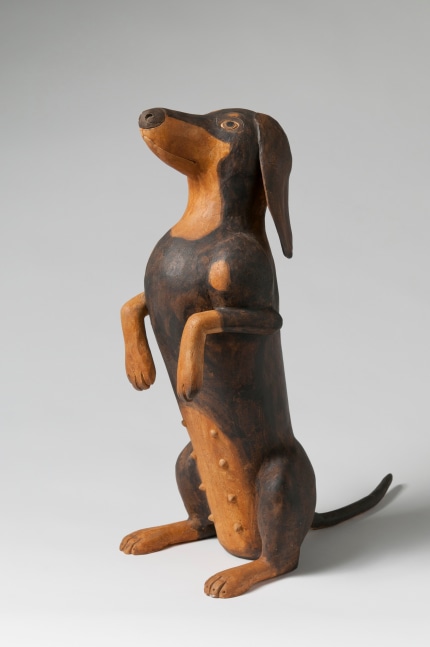 Sculpture of a small dog standing on its hind legs