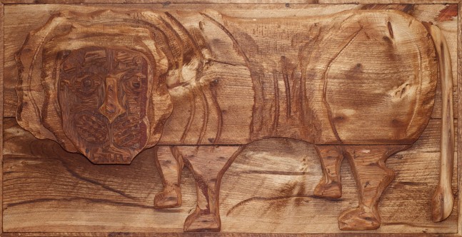Wooden relief sculpture of an abstracted lion