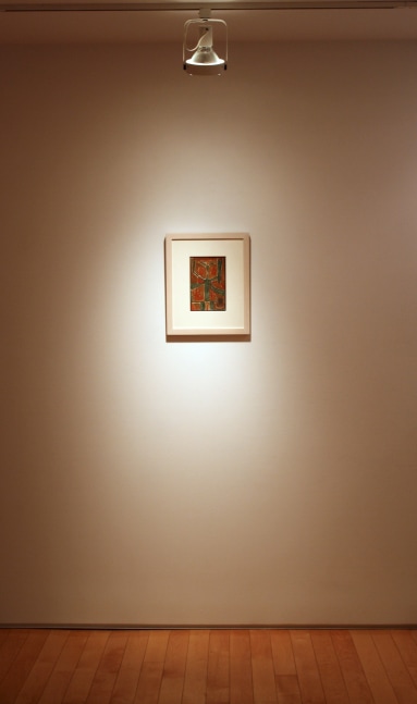 Photograph showing a view of an exhibition, with one small framed painting hanging on a grey wall