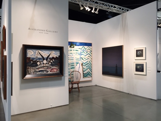Photograph showing a view of an exhibition space, with five paintings of various sizes hanging on white walls