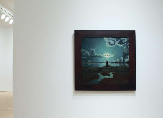 Photograph showing a view of an exhibition space, with one small painting hung on a white wall