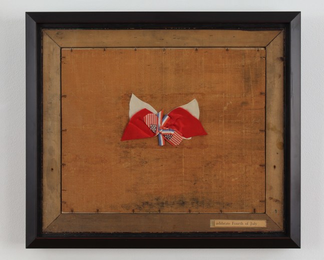 Framed collage with pieces of cloth in red, white and blue tied in a bow on a brown wooden surface and a cut out piece of text on the bottom right that reads &quot;celebrate Fourth of July&quot;