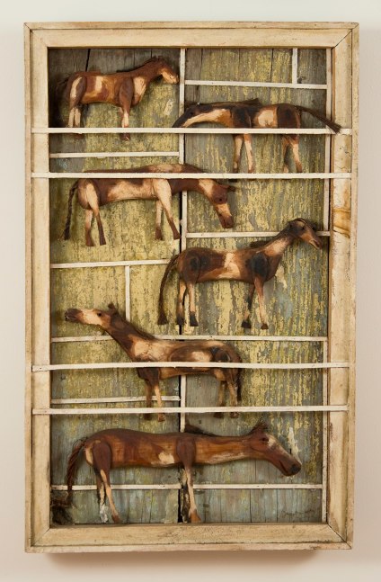Painted, wall-hanging wood sculpture of six horses in a pin