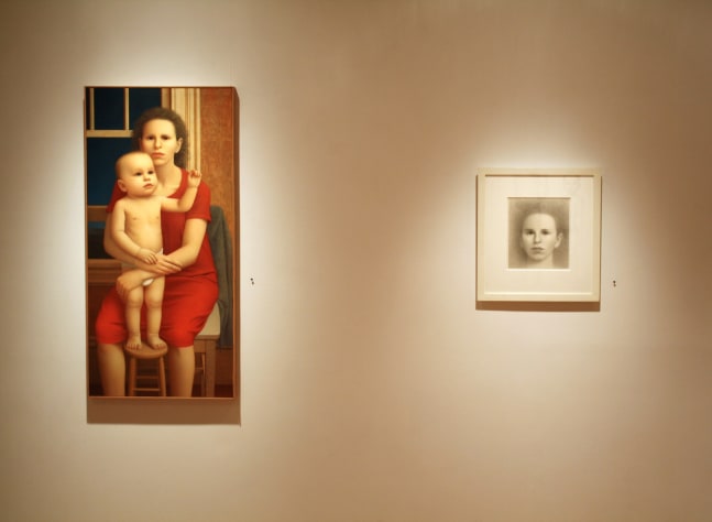 Photograph showing a view of an exhibition, with a framed painting and a small framed drawing hanging on a white wall