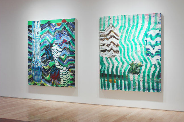 Photograph showing a view of an exhibition space, with two large paintings hanging on a white wall