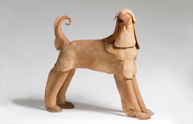 Side view of a sculpture of a long-haired dog