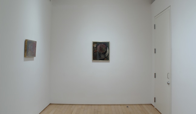 Photograph showing a corner view of an exhibition space, with two small paintings hung on white walls