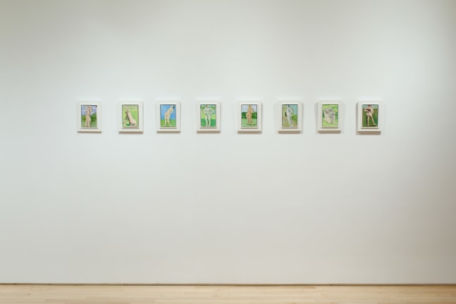 Photograph showing a view of an exhibition space, with a row of eight small paintings hung on a white wall
