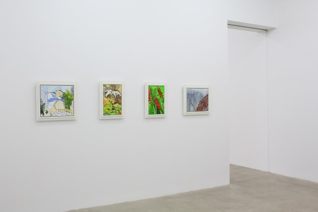Photograph showing a view of an exhibition space, with four paintings hanging on a white wall