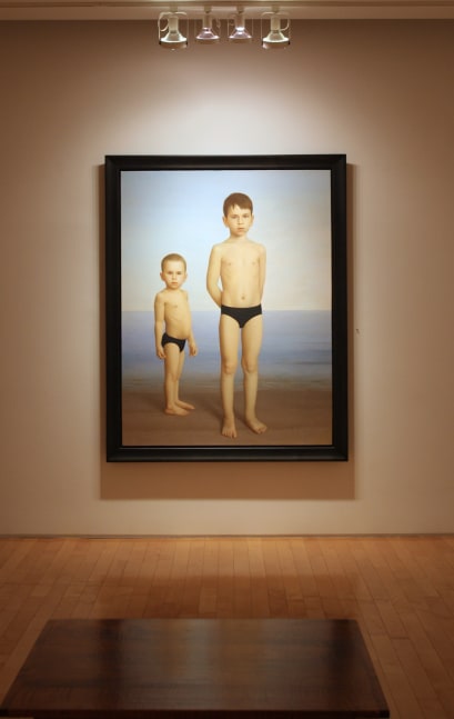 Photograph showing a view of an exhibition, with one large framed painting hanging on a white wall