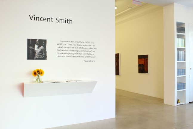 Photograph of a front view of an exhibition space, showing wall text