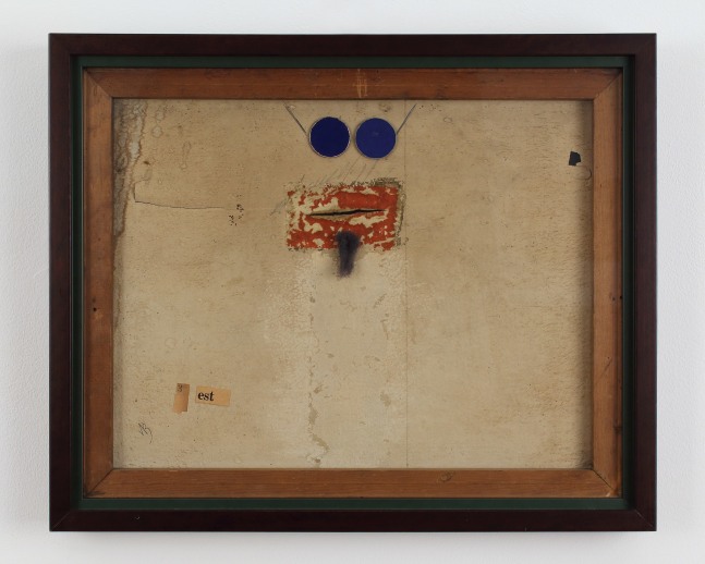 Framed collage constructed from various materials, with items in the shape of a face and goatee in the top center, and a piece of text reading &quot;3 est&quot; in the lower left corner