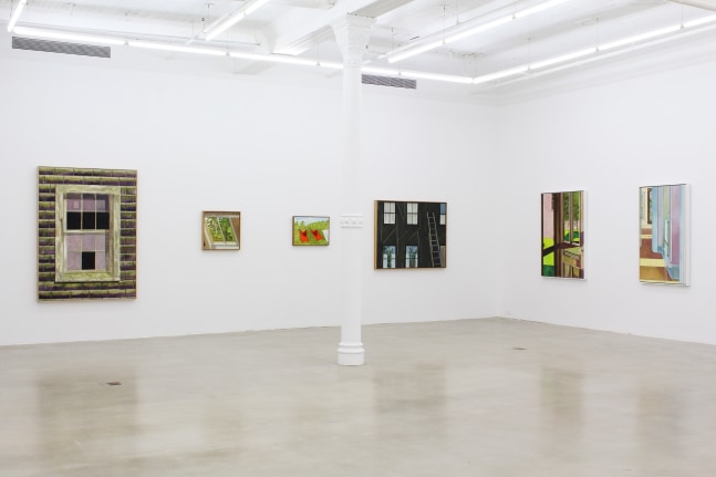 Photograph showing a corner view of an exhibition space, with six paintings hanging on white walls