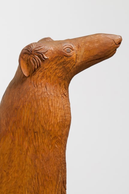 Detail view of a sculpture of a dog with a long, pointed nose