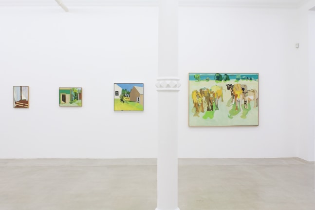 Photograph showing a view of an exhibition space, with four paintings hanging on a white wall