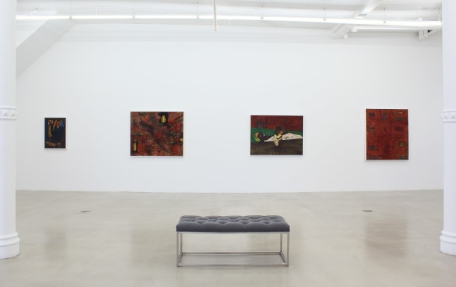Photograph showing a view of an exhibition space, with four paintings hanging on a white wall