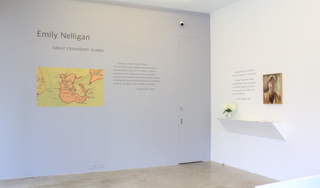 Photograph of one grey wall and one white wall showing exhibition text