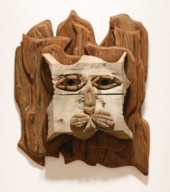 Wall-hanging wood sculpture of an abstracted lion's head