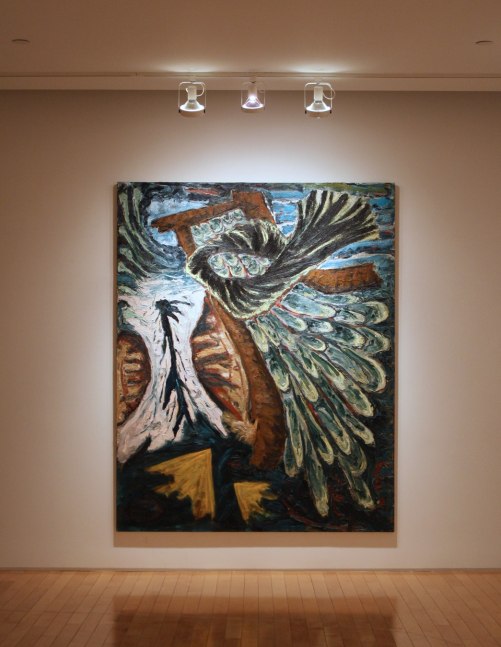 Photograph showing a view of an exhibition, with one large framed painting hanging on a white wall