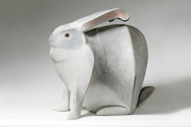 Side view of a sculpture of a white rabbit