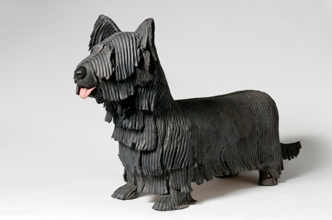 Three-quarter view of a sculpture of a small, shaggy dog