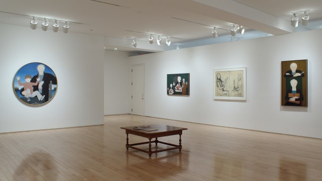 Photograph showing a corner view of an exhibition space, with four paintings hanging on white walls