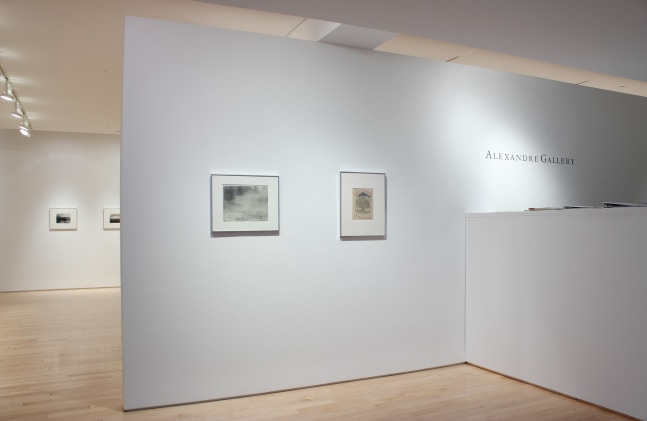 Photograph showing a view of an exhibition space, with two drawings hanging on a white wall