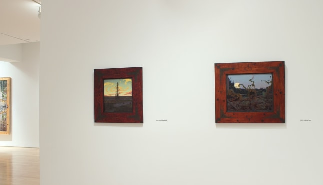 Photograph showing a view of an exhibition space, with two small painting hanging on a white wall