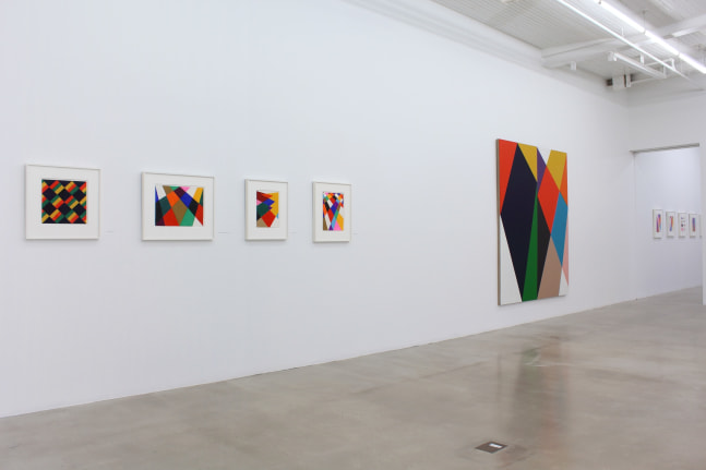 Photograph showing a view of an exhibition space, with eight paintings hanging on a white wall