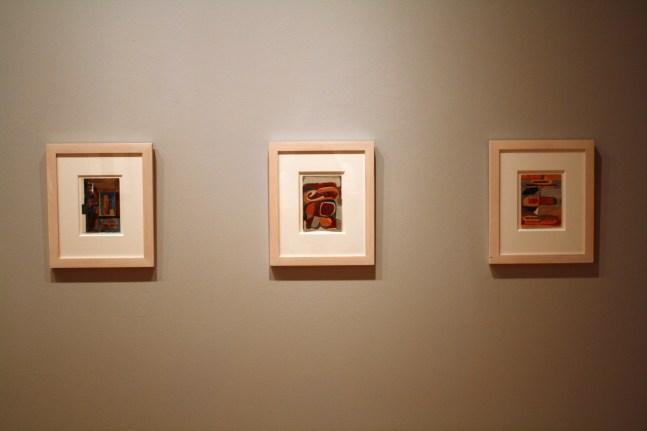 Photograph showing a view of an exhibition, with two small framed drawings hanging on a grey wall
