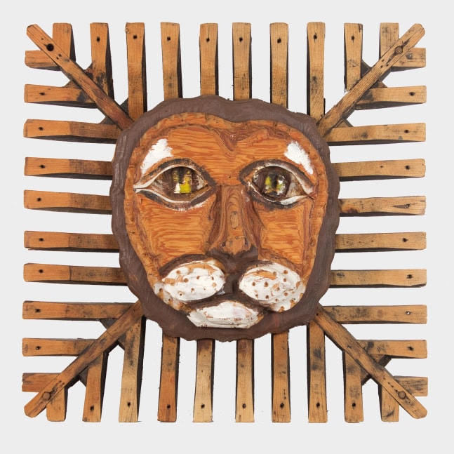 Wooden sculpture of an abstracted lion head