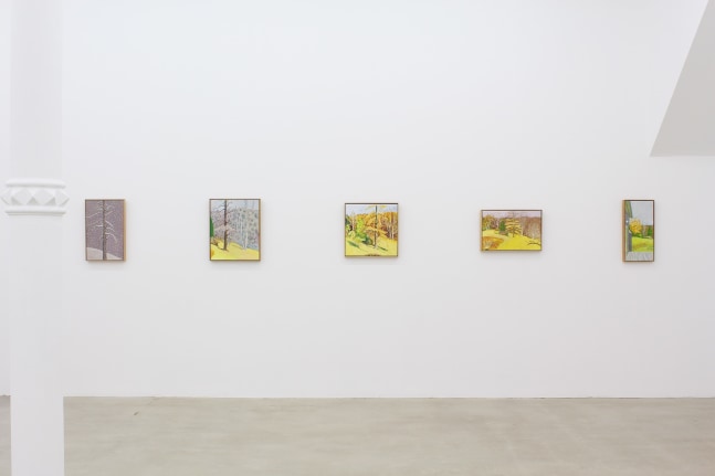 Photograph showing a view of an exhibition space with five paintings hung on a white wall