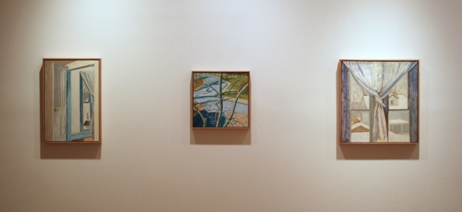 Photograph showing a view of an exhibition, with three small framed paintings hanging on a white wall