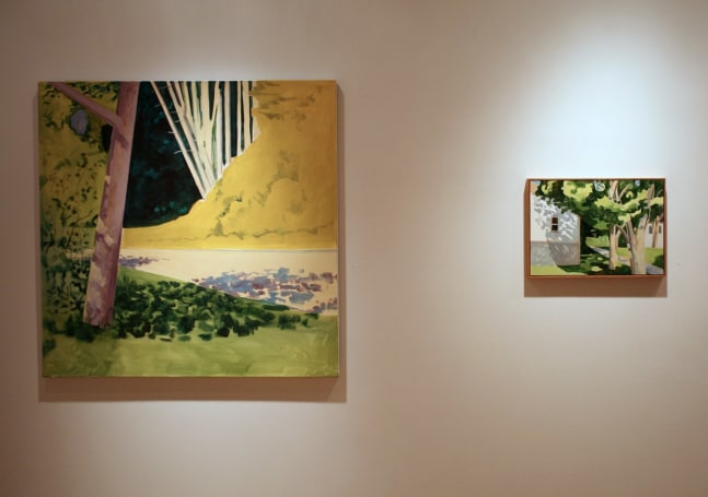 Photograph showing a view of an exhibition, with two paintings hanging on a white wall