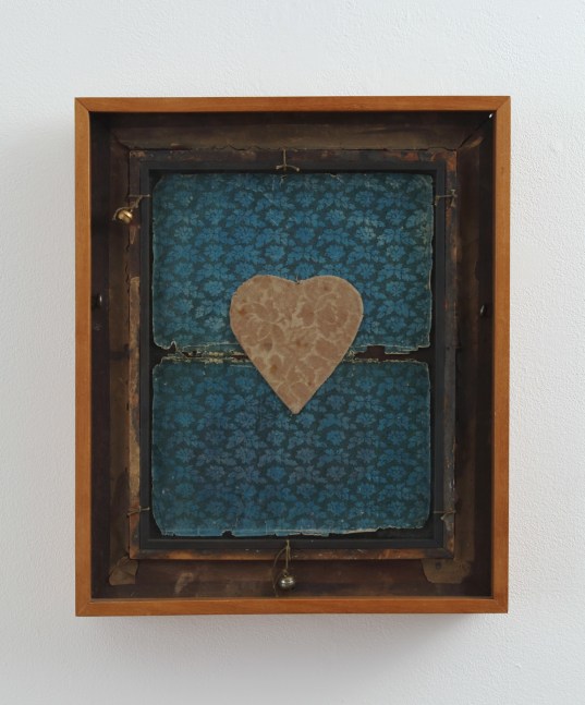 Framed collage made from two pieces of patterned paper and a heart in the center cut from patterned paper