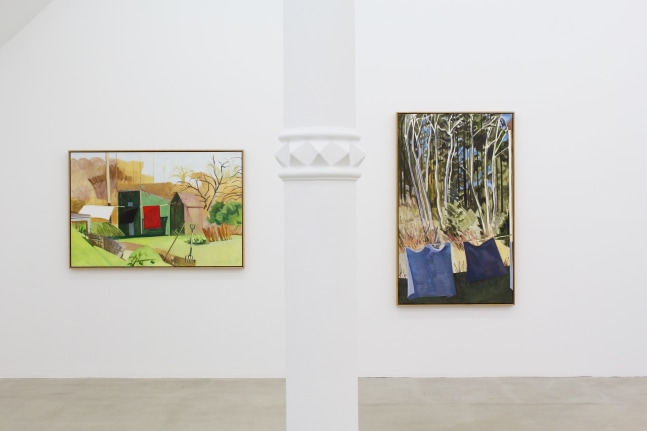 Photograph showing a view of an exhibition space with two paintings hung on a white wall