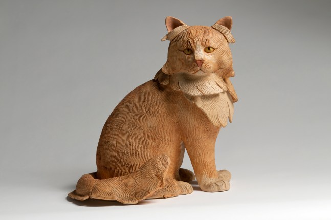 Sculpture of a long-haired cat sitting on its hind legs