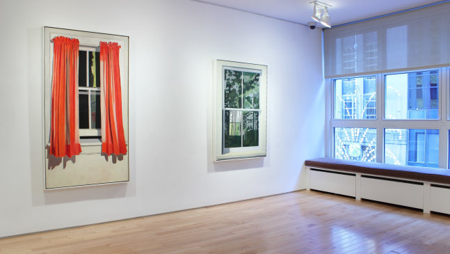 Photograph showing a view of an exhibition space, with two paintings hanging on a white wall