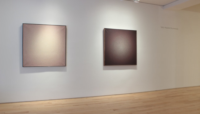 Photograph showing a view of an exhibition space, with two paintings hanging on a white wall