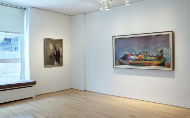 Photograph showing a corner view of an exhibition space with two paintings hanging on white walls
