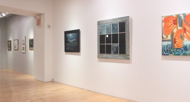 Photograph showing a view of an exhibition space, with three paintings hanging on a white wall