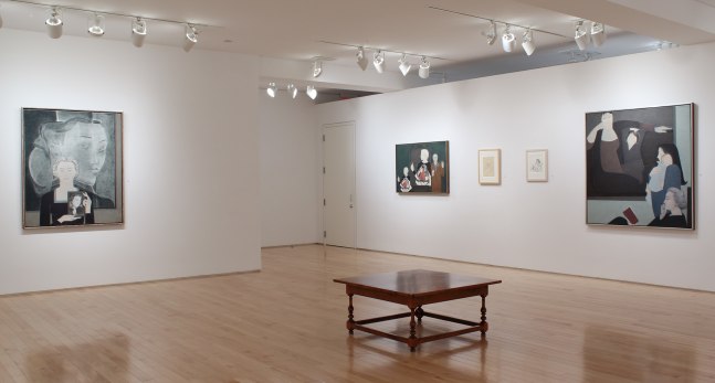Photograph showing a corner view of an exhibition space, with five paintings hung on white walls