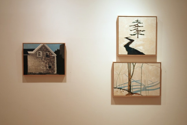Photograph showing a view of an exhibition, with three small framed paintings hanging on a white wall