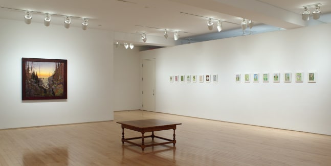 Photograph showing a corner view of an exhibition space, with one larger painting on the left wall and a row of sixteen small paintings on the other wall