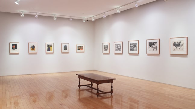 Photograph showing a corner view of an exhibition space with ten framed drawings hanging on white walls