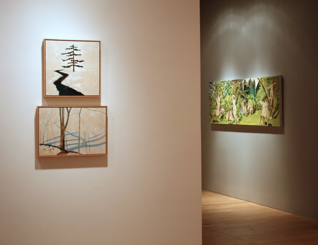 Photograph showing a view of an exhibition space, with two small framed paintings hanging on a white wall in the foreground, and a larger painting hanging on a grey wall in the distance