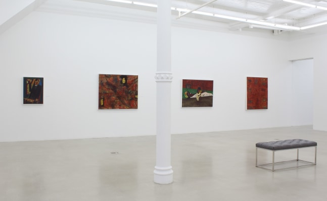 Photograph showing a view of an exhibition space, with four paintings hanging on a white wall