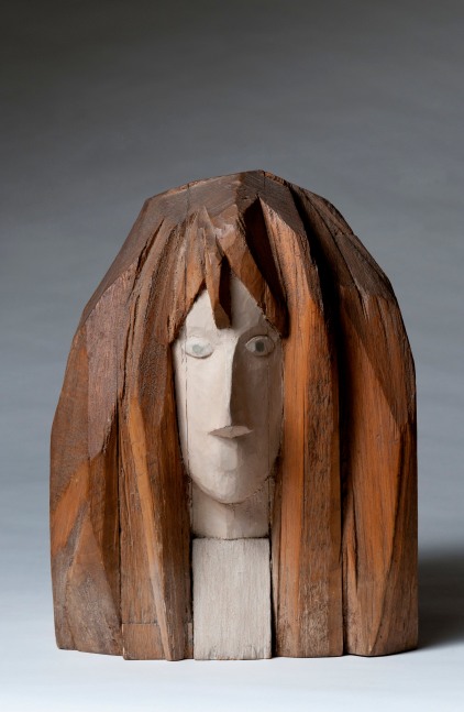Wood sculpture of the head of a woman from the neck up